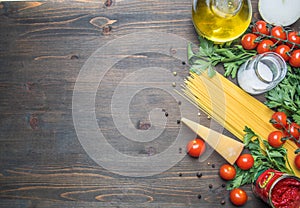 Cooking vegetarian pasta with cherry tomatoes, parsley, onion and garlic, butter, tomato paste and cheese, on rustic wooden back