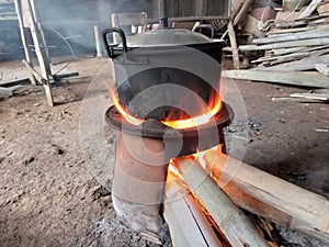 cooking water on a wood-fired stove in the backyard