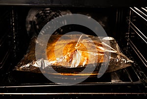 Cooking whole chicken inside cooking bag in oven.