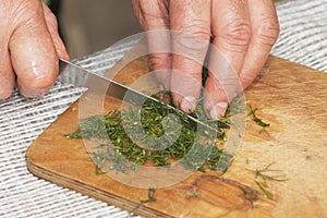 Cooking: woman hands cutting dill