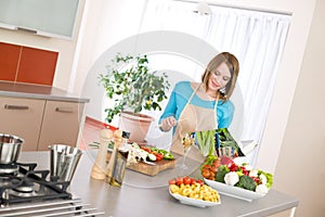 Cooking - Woman reading cookbook in kitchen