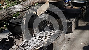 cooking in the yard of a broken house in the city of Mariupol