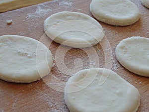 Cooking yeast dough. Working with dough in the kitchen. Close-up on rolled out dough