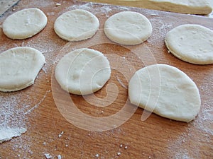 Cooking yeast dough. Working with dough in the kitchen. Close-up on rolled out dough