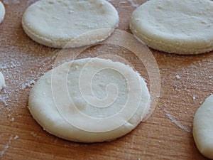 Cooking yeast dough. Working with dough in the kitchen. Close-up on rolled out dough