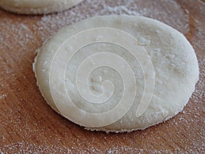 Cooking yeast dough. Working with dough in the kitchen. Close-up on rolled out dough