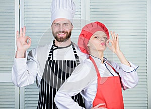 Cooking with your spouse can strengthen relationships. Teamwork in kitchen. Couple cooking dinner. Woman and bearded man