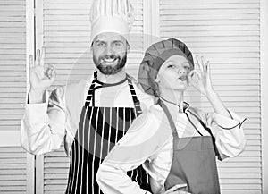 Cooking with your spouse can strengthen relationships. Teamwork in kitchen. Couple cooking dinner. Woman and bearded man