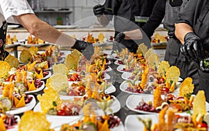 Cooks are garnishing appetizer plates