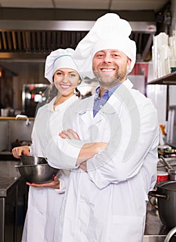 Cooks greeting customers at bistro