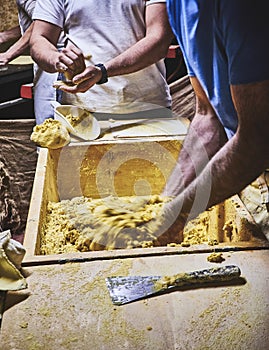 Cooks making dough for Tortillas on a kneading trough photo
