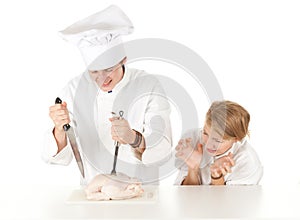 Cooks team preparing raw chicken