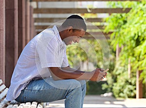 Cool african american guy looking at cell phone photo