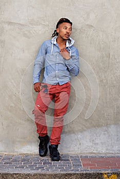 Cool african guy leaning against wall