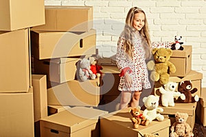 Cool apartments. happy child cardboard box. purchase of new habitation. happy little girl with toy. Cardboard boxes -