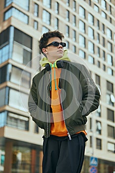 Cool attitude student shows his street style by dressing in neon fashions that speak to his trendy approach to city life