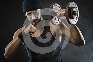 Cool attractive man lifting weights