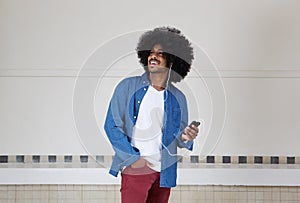 Cool black guy listening to music on mobile phone