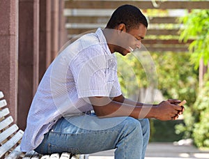 Cool black guy looking at cell phone