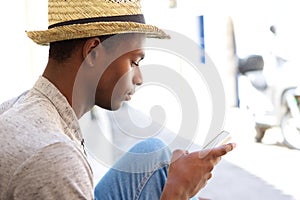 Cool black guy looking at mobile phone