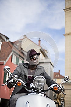 Cool black man riding a scooter