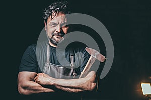Cool blacksmith portrait in workshop