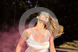 Cool blonde woman with long curly hair fluttering on wind with H