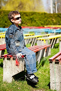 Cool boy sitting in a park