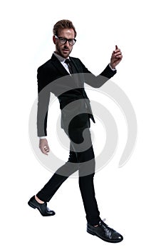 Cool businessman in black suit sensually stepping