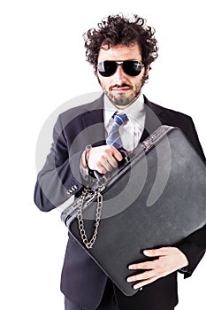 Cool businessman with chained suitcase