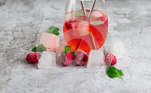Cool cocktail with ice and mint and raspberry. Summer.