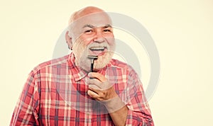 Cool and confident. barbershop concept. shaving accessories. unshaven old man has moustache and beard. shaving razor