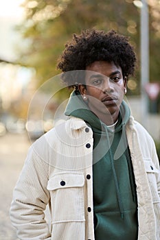 Cool confident young gen z hipster African American teen outdoors. Portrait