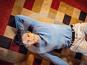 Cool dark-haired handsome young man laying on the floor