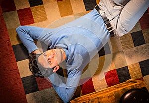 Cool dark-haired handsome young man laying on the floor