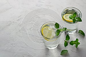 Cool drink with fresh lemon, mint leaves and ice. Lemonade, water with lemon