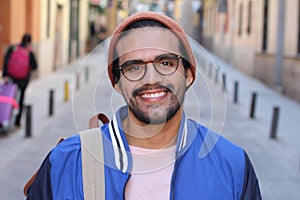 Cool ethnic man smiling in urban background