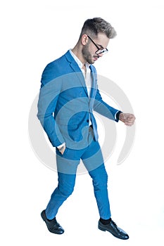Cool fashion man in blue suit holding hand in pocket and posing