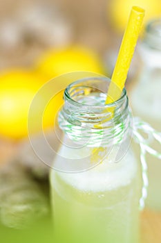 Cool fizzy drink with ginger, lime and lemon in a small bottle photo