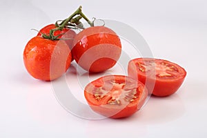 Cool fresh sliced tomatoes on white background