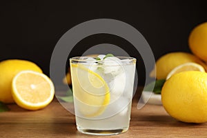 Cool freshly made lemonade and fruits on wooden table