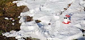 Cool funny Santa Claus with sun glasses sitting on the snow