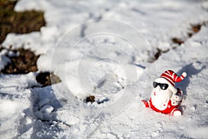 Cool funny Santa Claus with sun glasses sitting on the snow