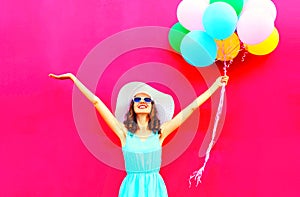 Cool girl with an air colorful balloons is having fun in summer