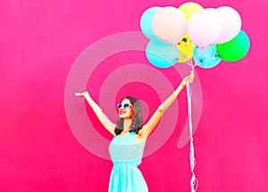 Cool girl with an air colorful balloons is having fun in summer