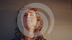 Cool girl chewing gum at evening street close up. Portrait woman blowing bubbles