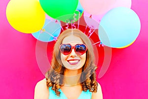 Cool girl having fun over an air colorful balloons pink