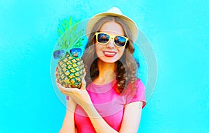 Cool girl with pineapple sunglasses wearing summer hat having fun