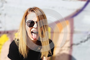 Cool girl with sunglasses screeming photo