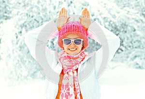 Cool girl wearing colorful knitted hat scarf having fun